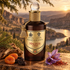 Penhaligon’s Halfeti Cedar stands beside cedar wood, dried fruits, and saffron crocuses above a winding river at sunset.