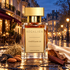 Régalien Châtelain 22 perfume stands on a reflective Brussels street at blue hour, surrounded by tonka beans, almonds, hay, tobacco, rosewood, and cream silk.
