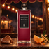Serge Lutens Baptême du Feu beside heart-shaped gingerbread, tangerine, candied peel, and osmanthus on a wooden counter under warm fairground lights.