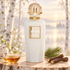 Slava Zaitsev Blanc Eternel on pale birch wood beside maple syrup, licorice roots, and pine, with a luminous misty woodland behind it.