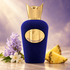 Sospiro Accento Viola velvet bottle beside pineapple wedges, lavender hyacinth, and white jasmine against a softly lit violet and ivory background.