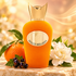 Sospiro Dolce Melodia orange bottle with a whole mandarin, gardenia and blackcurrants on cream stone in golden light.