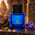 Thameen Carved Oud with dark oud wood, cardamom pods, and a purple iris before Indian temple carvings in warm light.