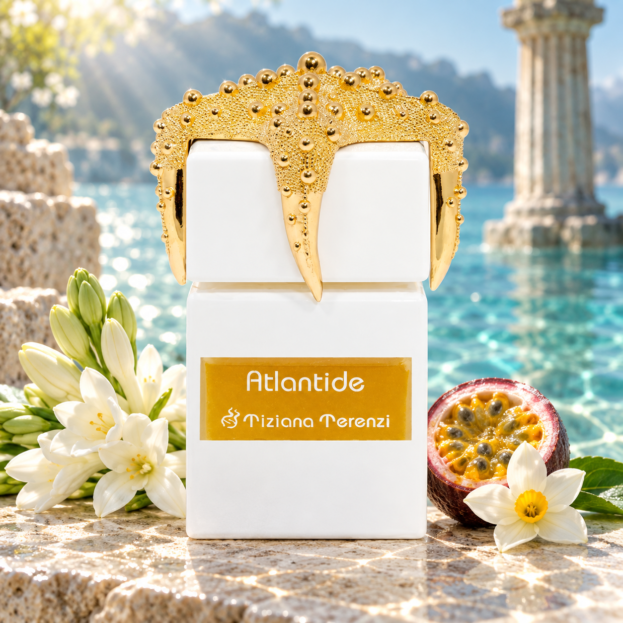 Tiziana Terenzi Atlantide on pale stone beside white flowers, passion fruit, and narcissus, overlooking turquoise water and an imagined classical ruin.