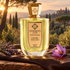 Unique’e Luxury Chypre Toscano on brown leather beside lavender and a saffron flower, overlooking wooded Tuscan hills in golden evening light.