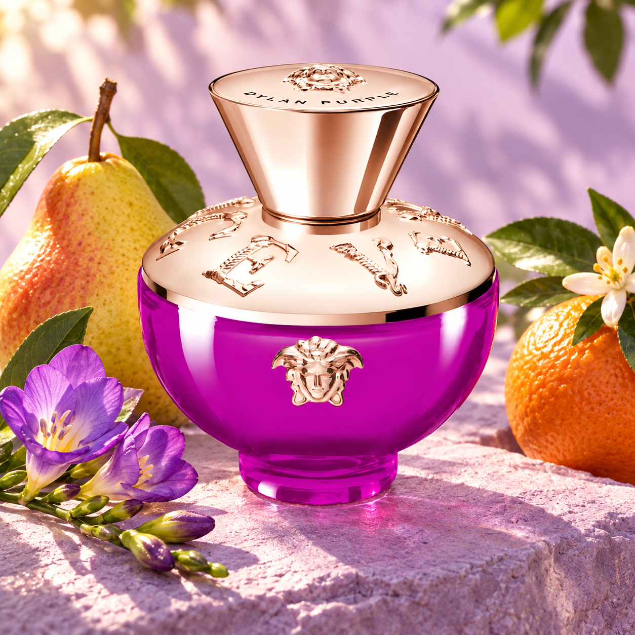 Versace Dylan Purple Pour Femme bottle with whole pear, orange and purple freesias on lilac stone in soft sunlight.