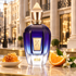 Xerjoff JTC 400 with honeycomb, orange, and orange blossoms against a warmly lit London shopping street.