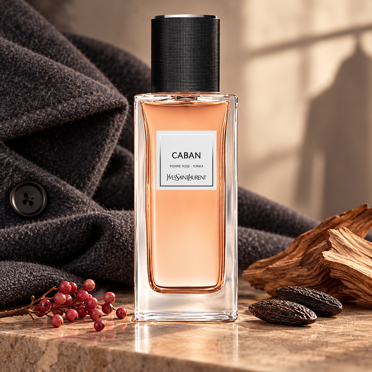 Yves Saint Laurent Caban beside charcoal wool, pink pepper, tonka beans, and sandalwood in warm window light.