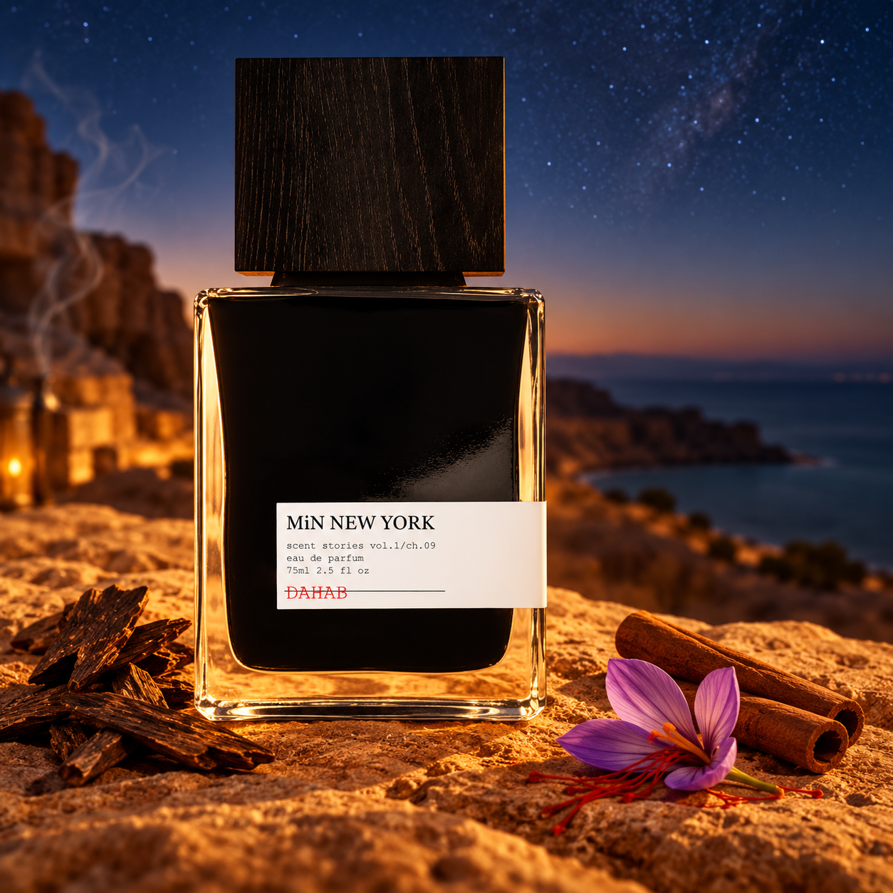 MiN New York Dahab bottle beside oud wood, cinnamon and a saffron crocus on sandstone above a desert coast under stars.