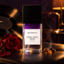 Bohoboco Dark Vinyl Musk bottle beside a red rose and incense resin on black leather with a vinyl record and warm lounge lighting.