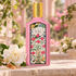 Gucci Flora Gorgeous Gardenia on pale stone with a white gardenia, pear blossoms and brown sugar crystals in a softly lit pink garden.