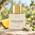 Nishane Hacivat on pale stone with a pineapple wedge, oakmoss and jasmine in soft summer light.