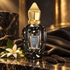 Xerjoff Homme Anniversary on dark marble with orange blossom, tonka beans and black leather in golden light.