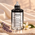 Maison Margiela Replica Ideal One bottle on pale stone beside lavender and orange blossom with softly draped ivory fabric.
