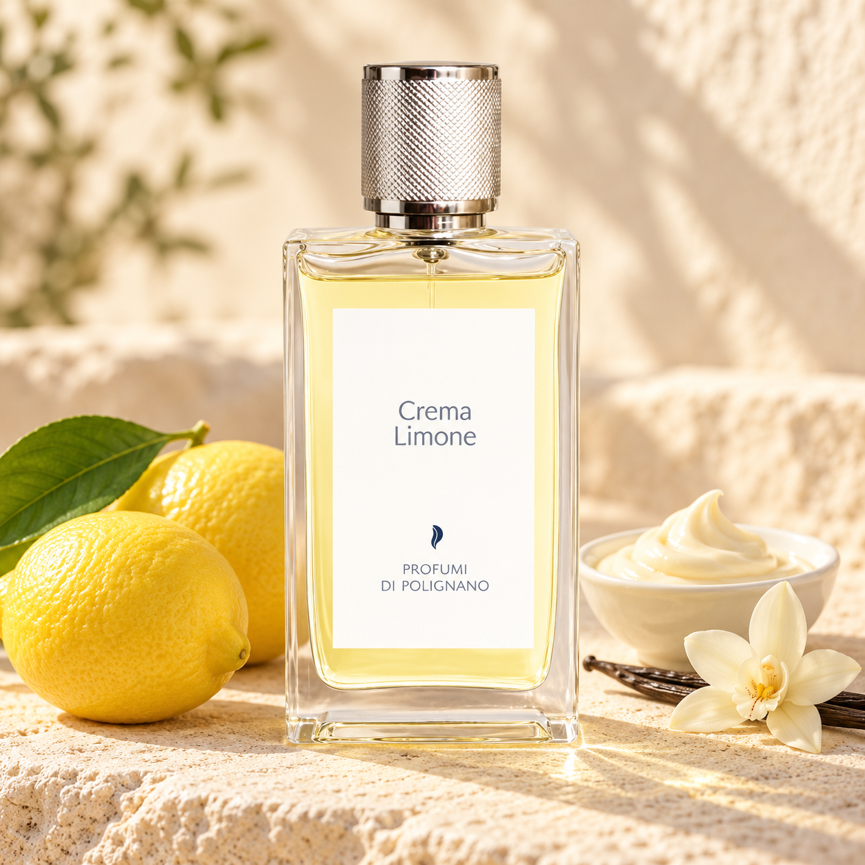 Profumi Di Polignano Crema Limone bottle with whole lemons, vanilla cream and an orchid on sunlit cream stone.